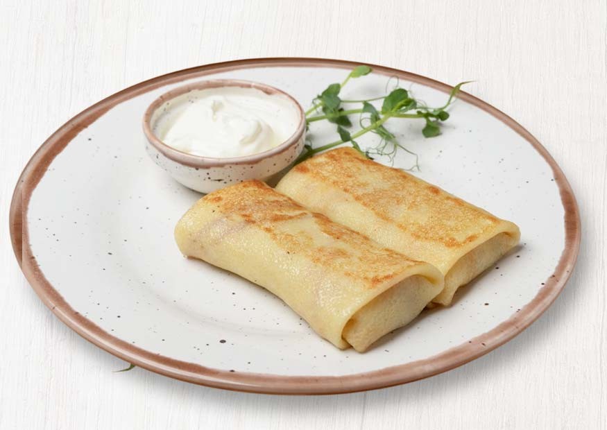 Homemade pancakes with meat, fried onion and egg